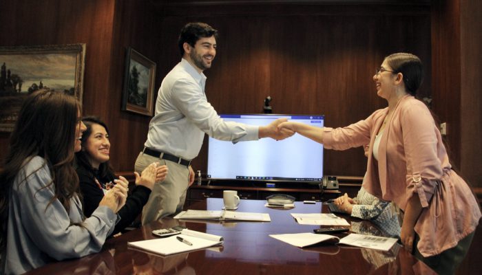 Meeting with Client The chief people's officer of CKH Group Nick shaking hands with a recently joined member in the meeting room