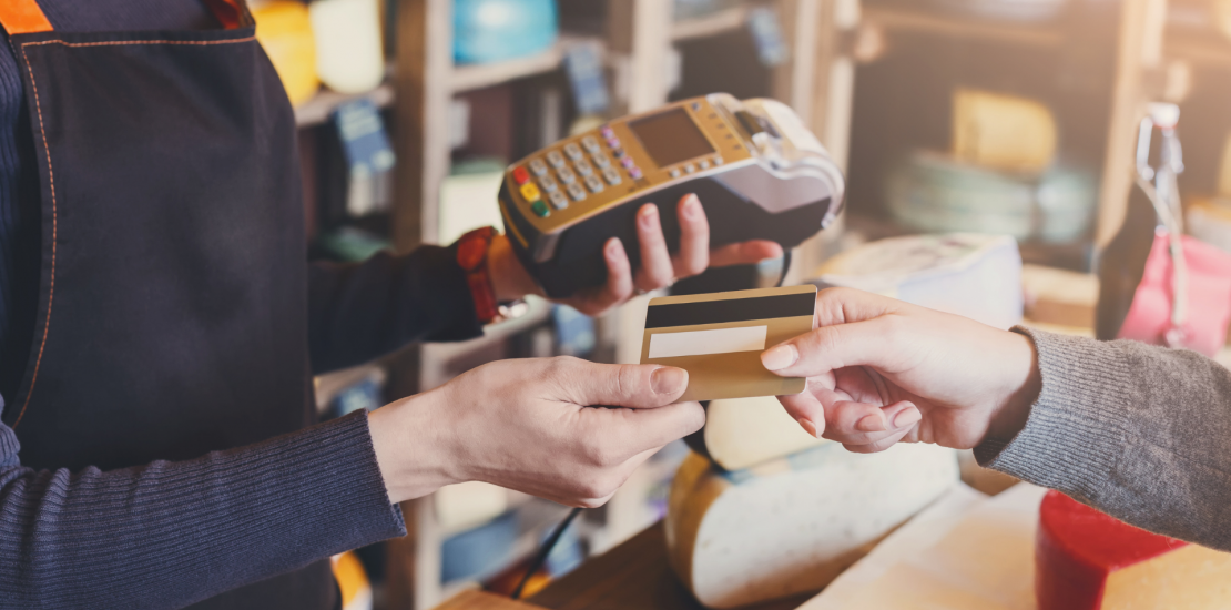 Representative graphic of a customer doing a debit card transaction at a shop